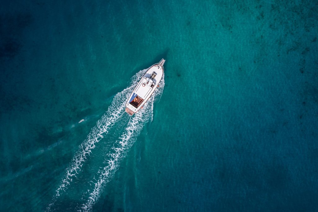 Sleek boat gliding on the serene Floridian waters at sunset.